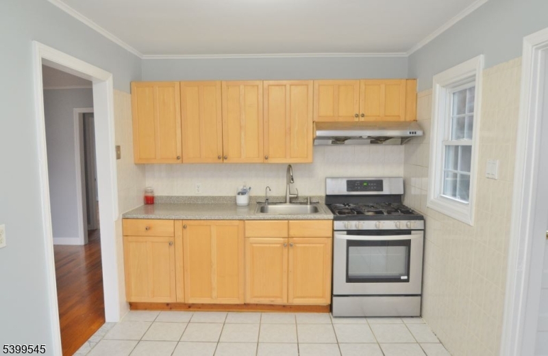 11 Bogota Road Parsippany, NJ 07054 - Photo 2 of 12 a kitchen with a stove top oven sink and cabinets