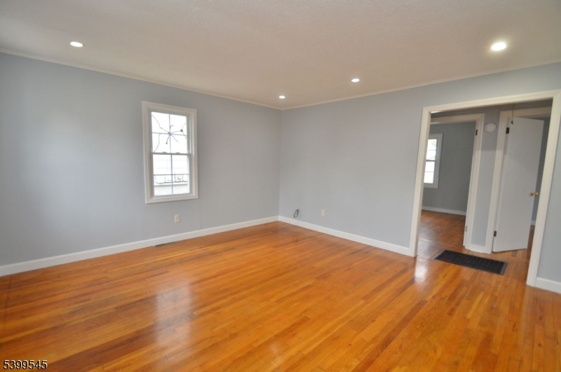11 Bogota Road Parsippany, NJ 07054 - Photo 6 of 12 an empty room with wooden floor and windows