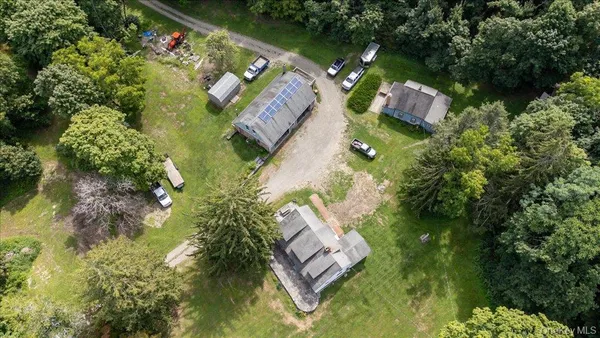 an aerial view of a house with a yard