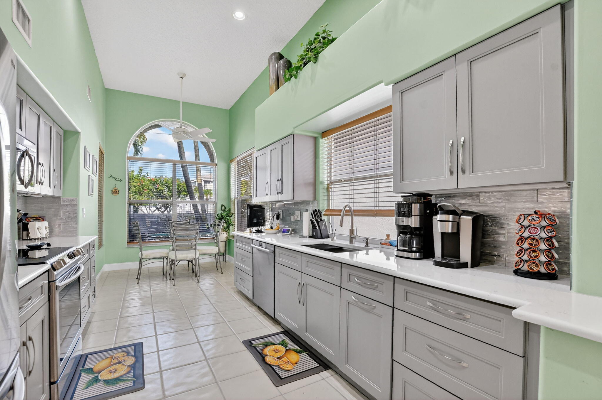 7816 Travelers Tree Drive Boca Raton, FL 33433 - Photo 13 of 61 a kitchen with stainless steel appliances granite countertop a sink and cabinets