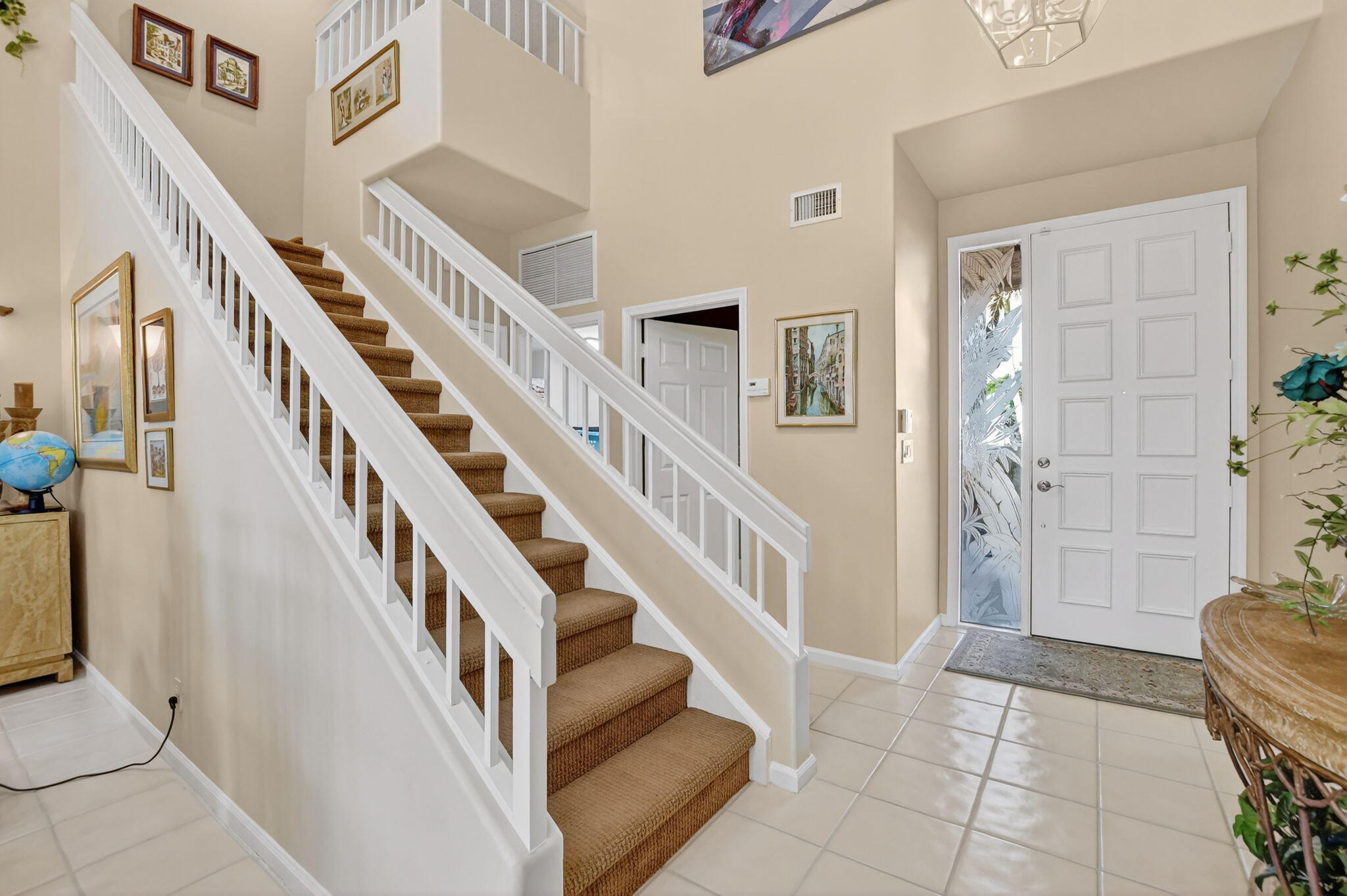 7816 Travelers Tree Drive Boca Raton, FL 33433 - Photo 29 of 61 a view of staircase with lots of frames on wall and a potted plant