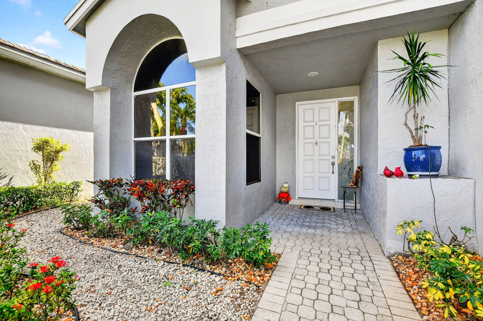 7816 Travelers Tree Drive Boca Raton, FL 33433 - Photo 3 of 61 a front view of a house with a garden