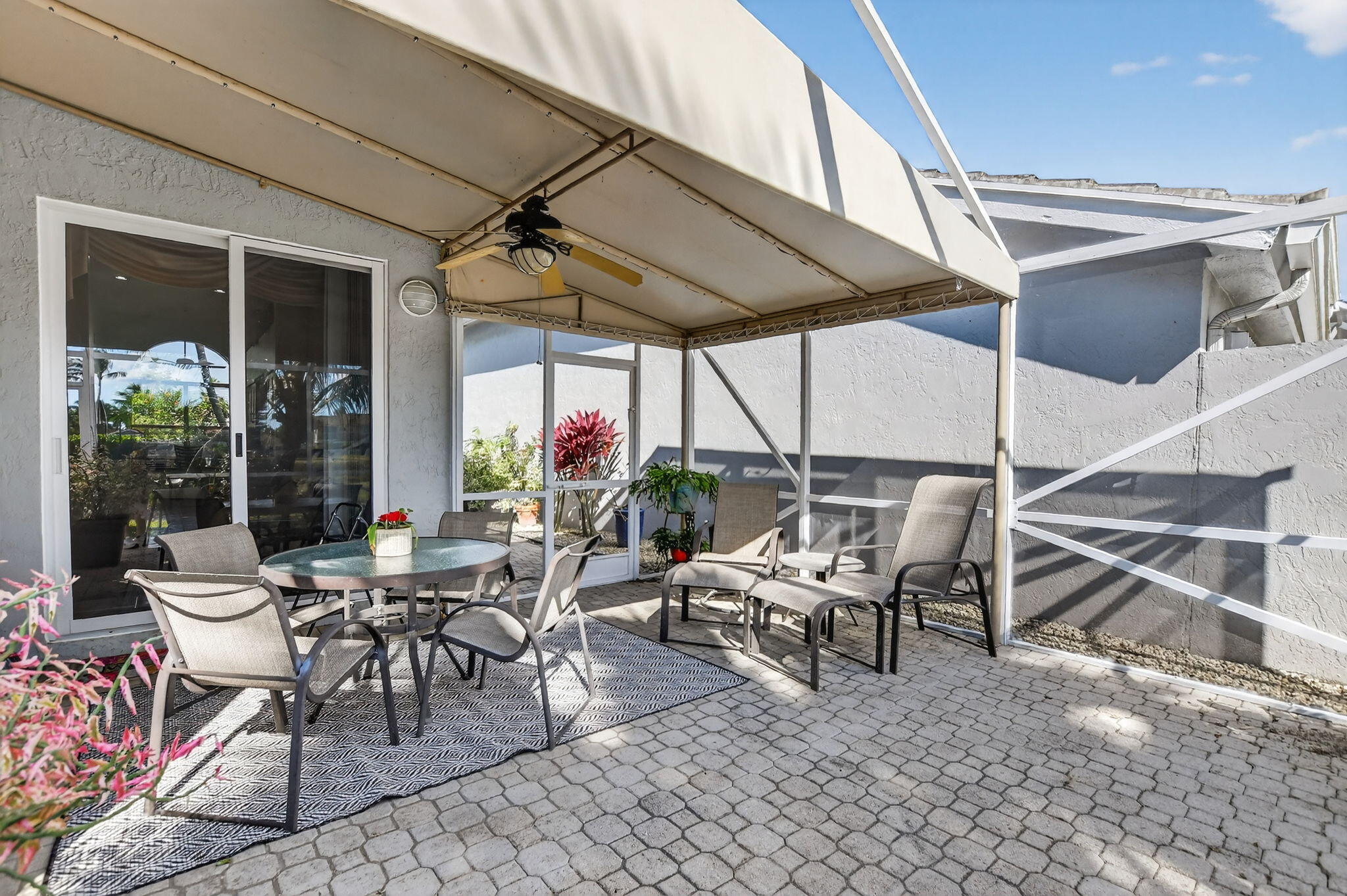 7816 Travelers Tree Drive Boca Raton, FL 33433 - Photo 42 of 61 a view of a patio with a table and chairs