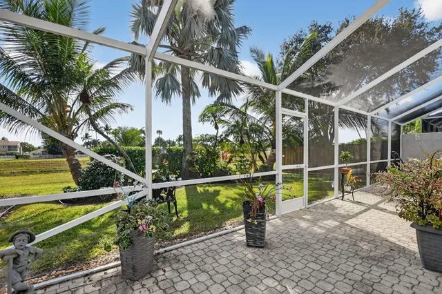 an aerial view of a house with a swimming pool garden and patio