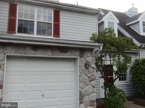 a front view of a house with garage