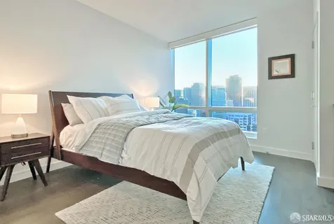 a bed sitting in a bedroom next to a window