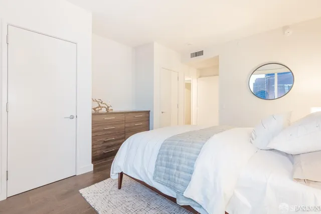 a bedroom with a bed and a cabinets