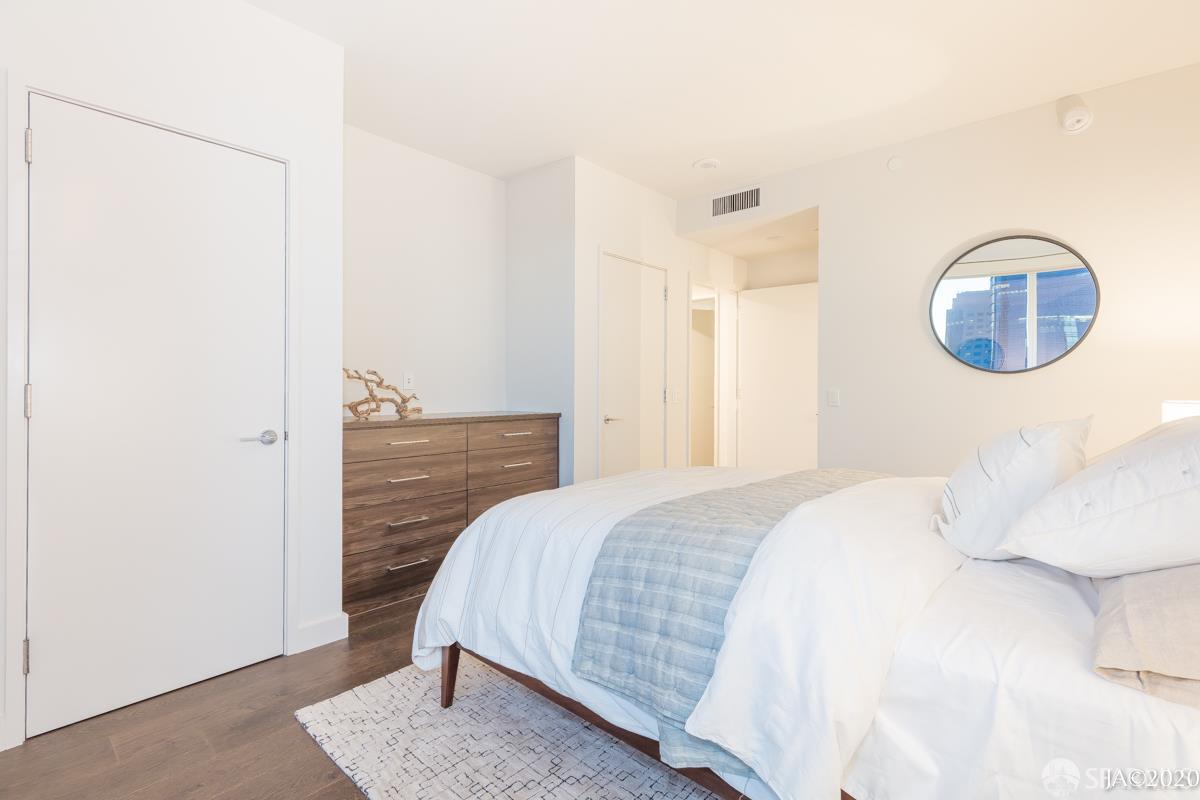 488 Folsom Street, Unit 4102 San Francisco, CA 94105 - Photo 39 of 46 a bedroom with a bed and a cabinets