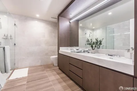 a bathroom with a double vanity sink mirror double and shower