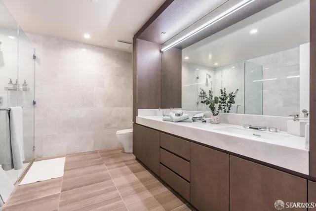 a bathroom with a double vanity sink mirror double and shower