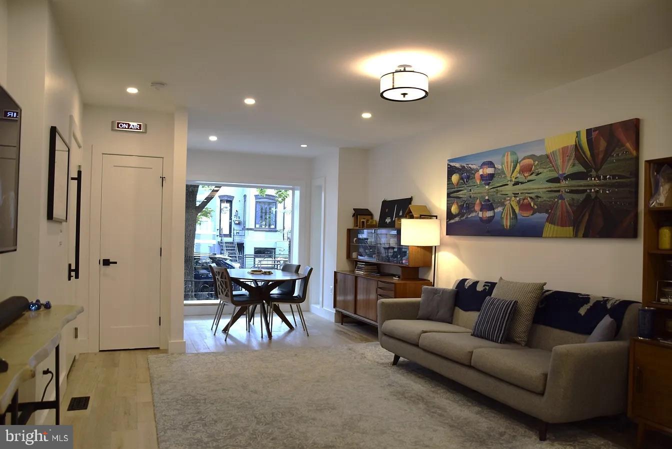 718 6th Street Northeast, Unit 1 Washington, DC 20002 - Photo 3 of 21 a living room with furniture and a large window