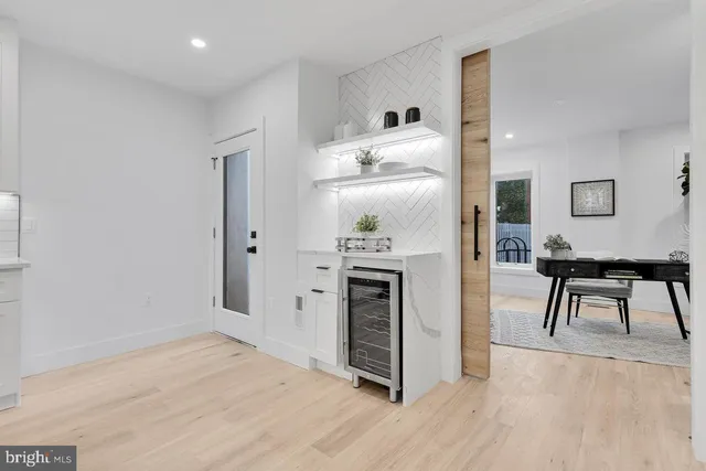 a open kitchen with white cabinets and stainless steel appliances