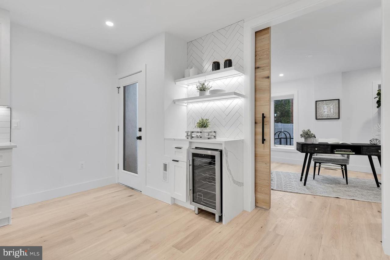 718 6th Street Northeast, Unit 1 Washington, DC 20002 - Photo 8 of 21 a open kitchen with white cabinets and stainless steel appliances