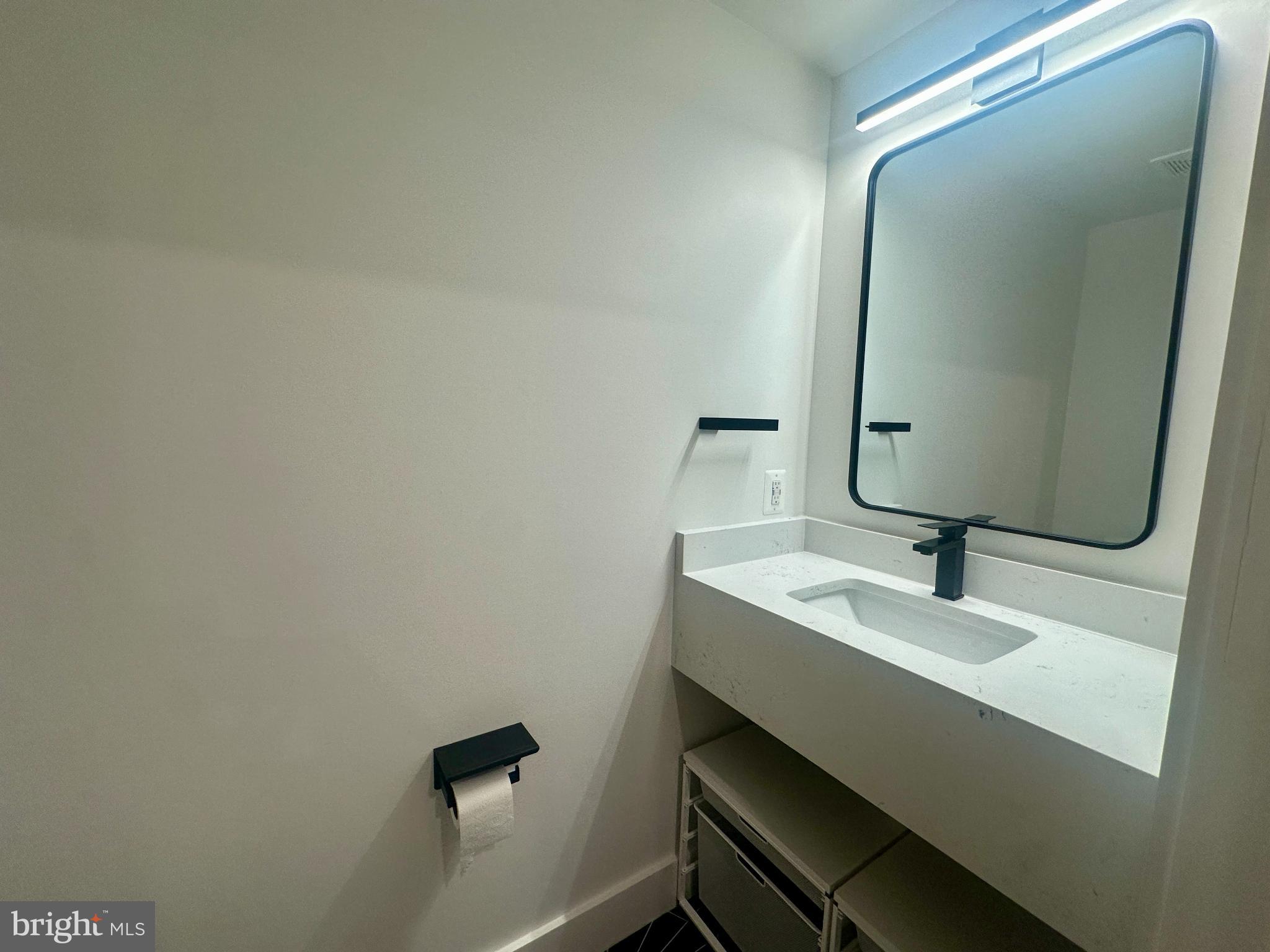 718 6th Street Northeast, Unit 1 Washington, DC 20002 - Photo 9 of 21 a bathroom with a sink and mirror