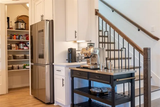a kitchen with stainless steel appliances granite countertop a refrigerator and a stove top oven