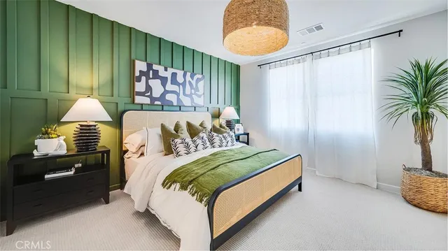 a bedroom with a bed and painting on the wall