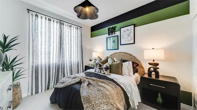 a bedroom with a bed and a large mirror