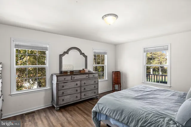 a bathroom with a sink toilet vanity and shower