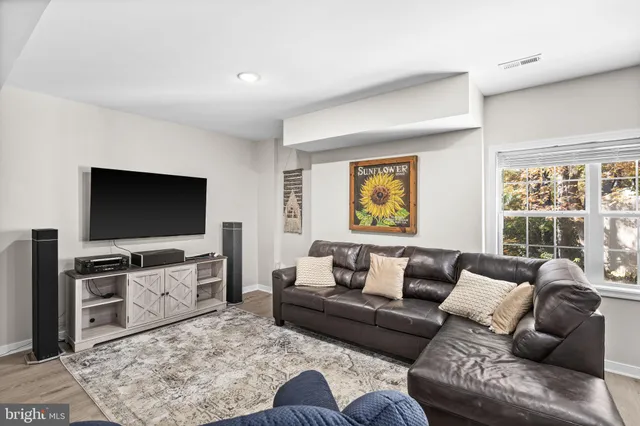 a view of a house with a small yard and wooden fence