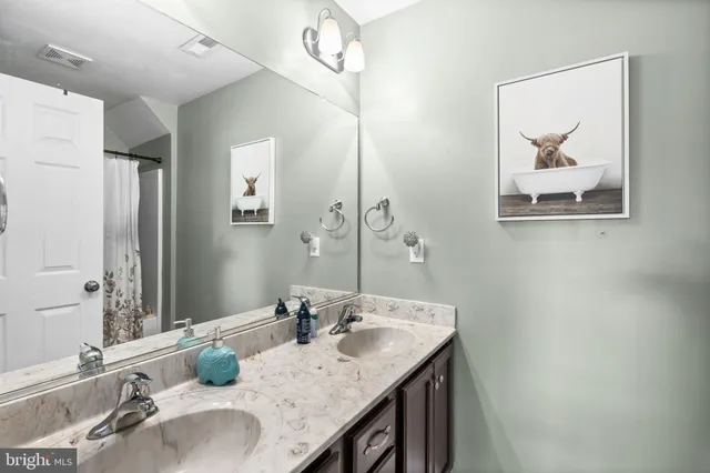 a view of a house with a big yard and large trees