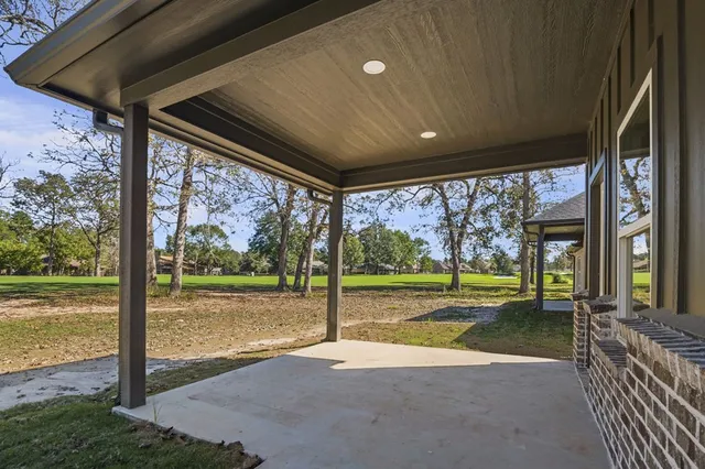 a view of a house with a big yard and porch
