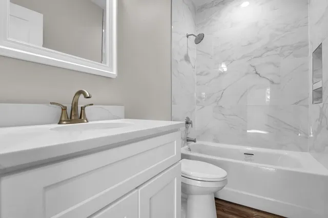 a bathroom with a sink a toilet and a bathtub