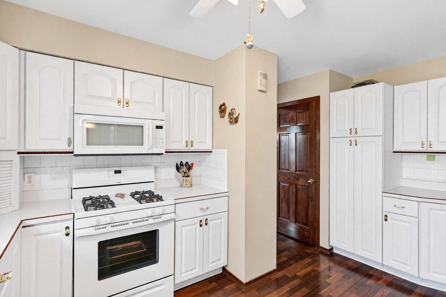 842 Pin Oak Circle Cary, IL 60013 - Photo 2 of 37 a kitchen with white cabinets and white appliances