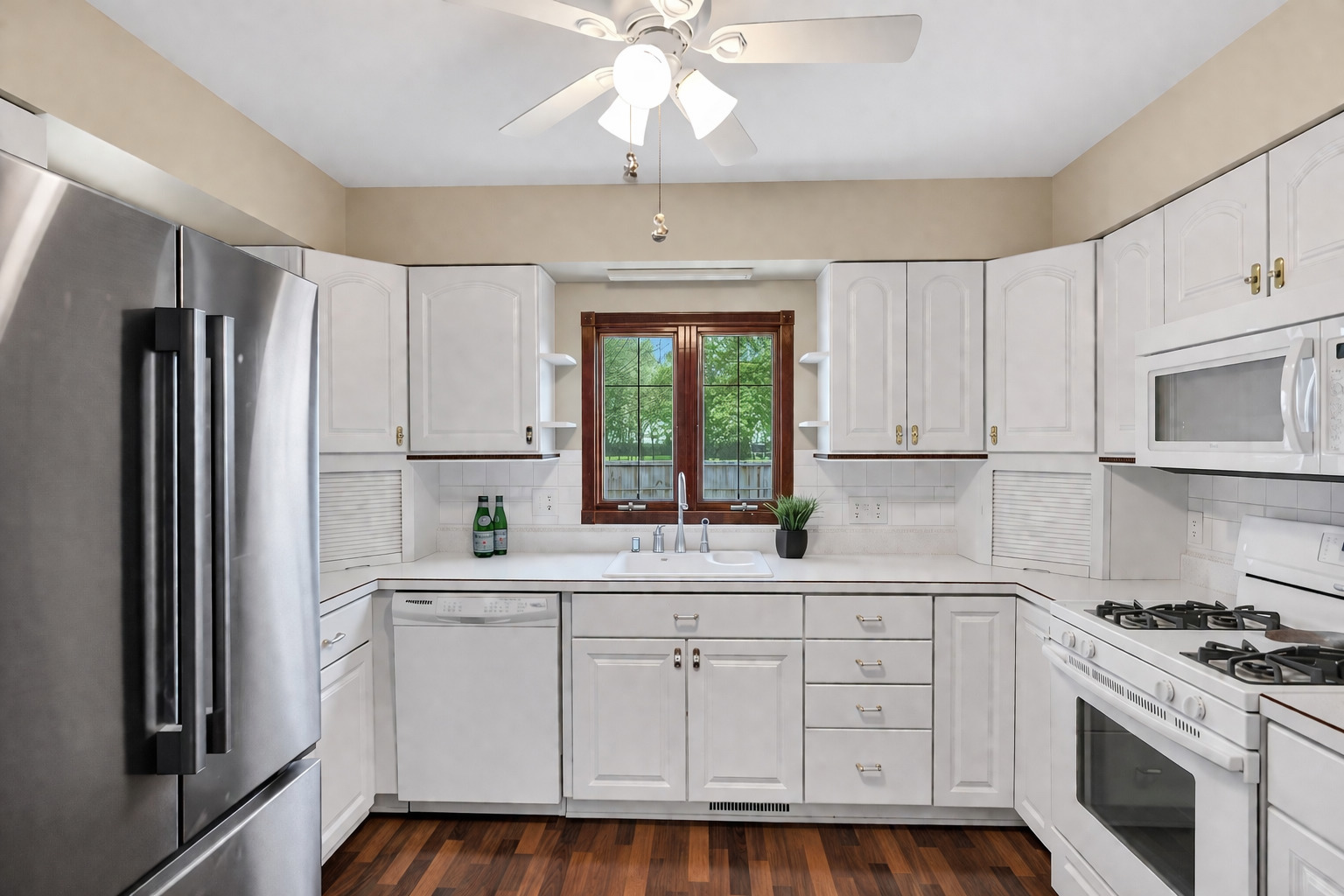 842 Pin Oak Circle Cary, IL 60013 - Photo 3 of 37 a kitchen with white cabinets and white appliances