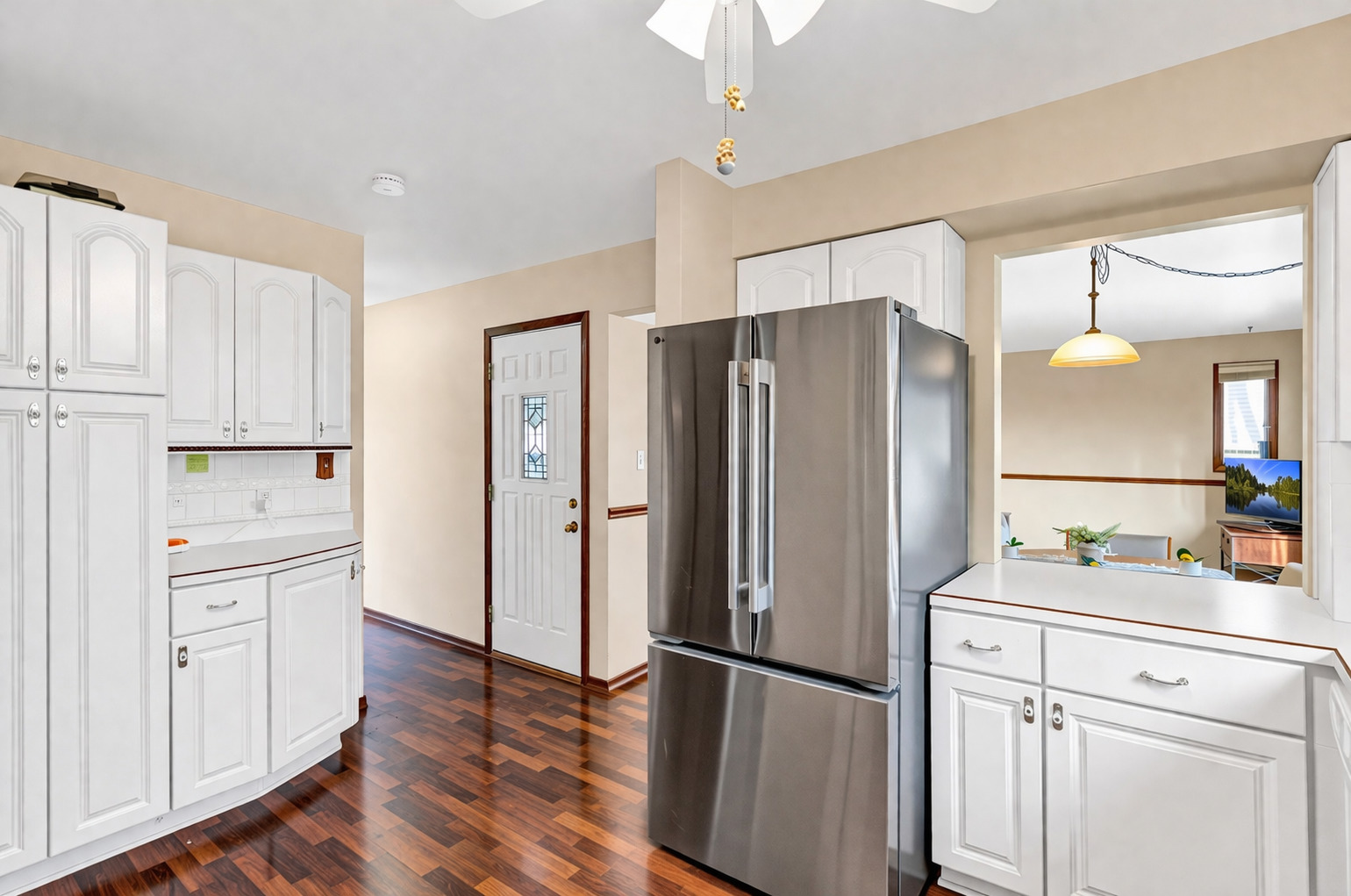 842 Pin Oak Circle Cary, IL 60013 - Photo 5 of 37 a kitchen with white cabinets and stainless steel appliances