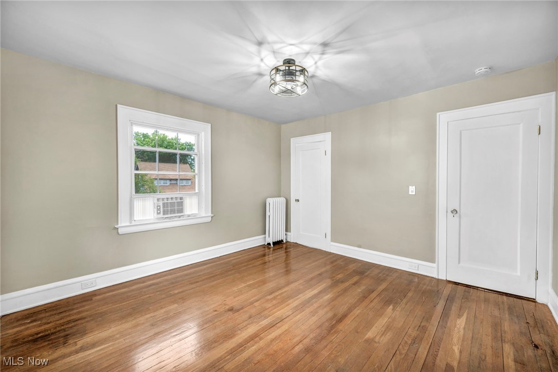 2980 East Overlook Road Cleveland, OH 44118 - Photo 27 of 49 Empty room featuring radiator heating unit and hardwood / wood-style floors