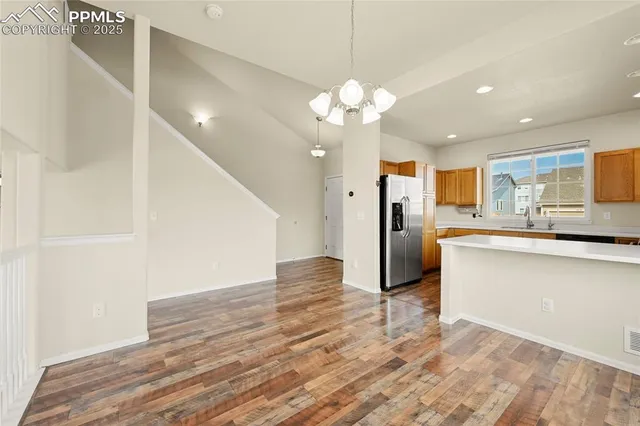 a view of a kitchen with a sink and a refrigerator