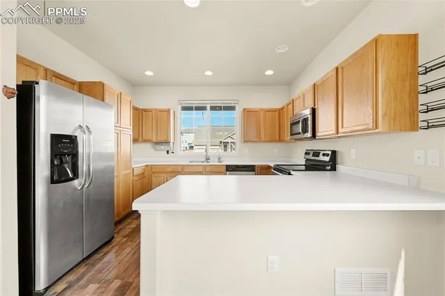a kitchen with stainless steel appliances a refrigerator sink and cabinets