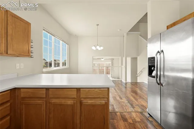 a kitchen with kitchen island a counter top space cabinets and stainless steel appliances