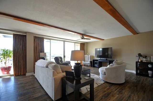 a living room with fireplace furniture and a flat screen tv