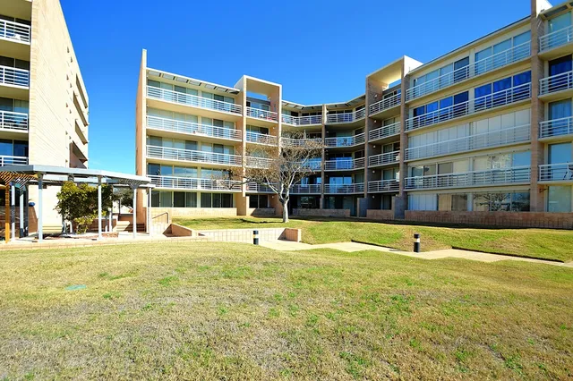 a building outdoor space with patio furniture and potted plants