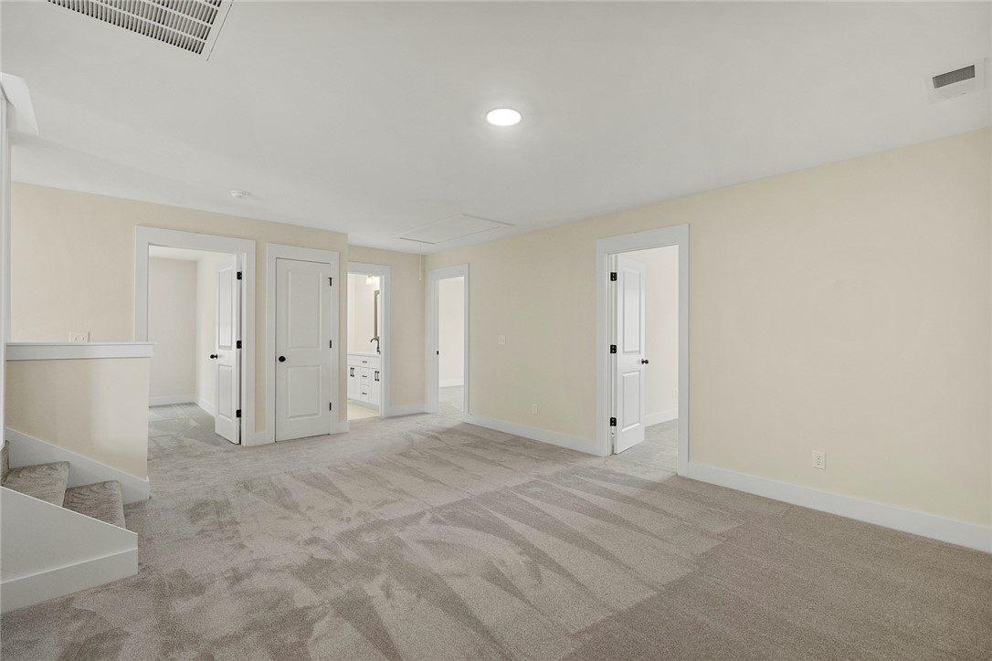 100 Garden Gate Drive Anderson, SC 29621 - Photo 26 of 43 This spacious bonus room features soft carpeting and recessed lighting, ready for your personalized touch.