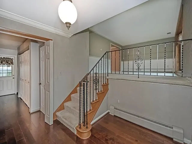 a view of an entryway with wooden floor