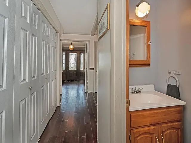 a view of a hallway view with wooden floor and staircase