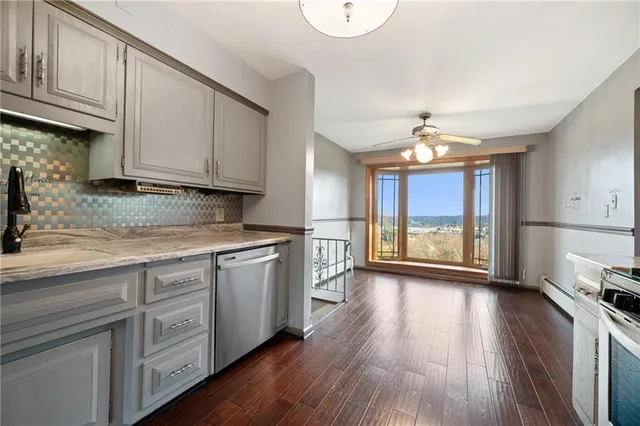 a kitchen with stove cabinets and wooden floor