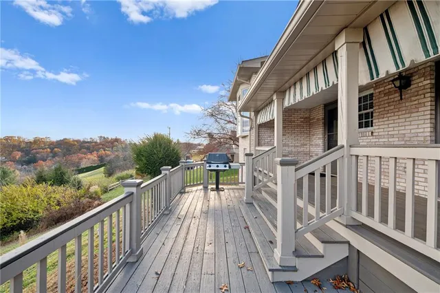 a view of a balcony with wooden floor and iron stairs