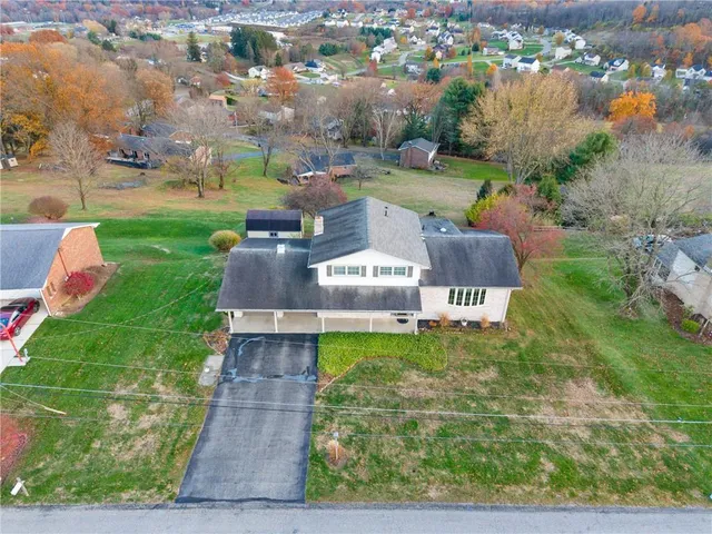 an aerial view of a house with yard swimming pool and outdoor seating