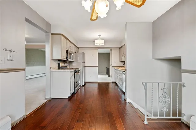 a view of a kitchen center island wooden floor and electronic appliances