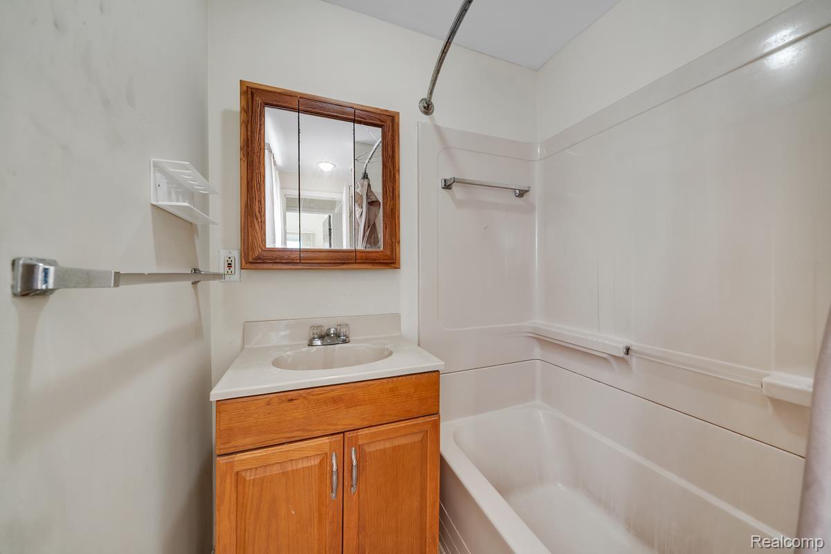 8620 Stephens Road Warren, MI 48089 - Photo 12 of 15 Bathroom with vanity and shower combination