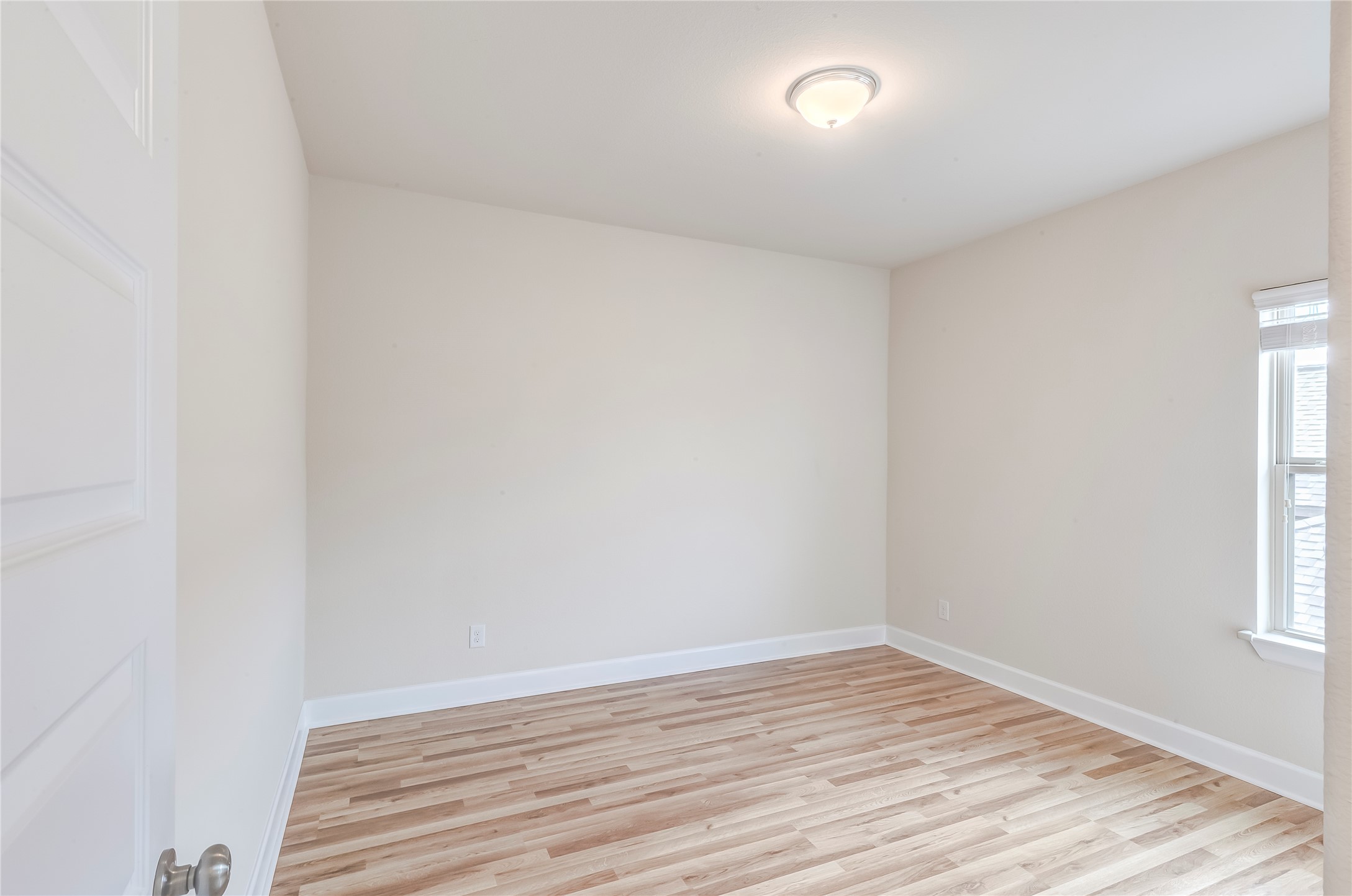 345 Fort Cobb Way Georgetown, TX 78628 - Photo 29 of 38 Gleaming wood-look floors and neutral walls anchor this versatile space illuminated by natural light.