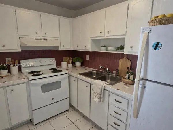 a kitchen with cabinets appliances and a sink