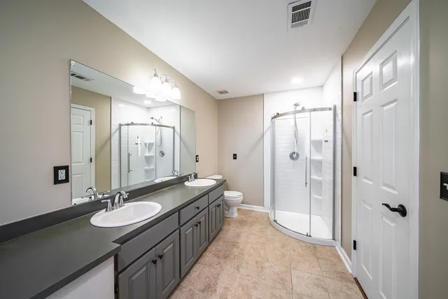a bathroom with a sink double vanity shower and a mirror