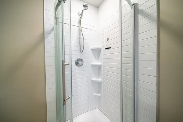 a bathroom with a glass shower door