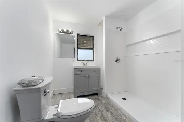 a bathroom with a toilet sink and shower