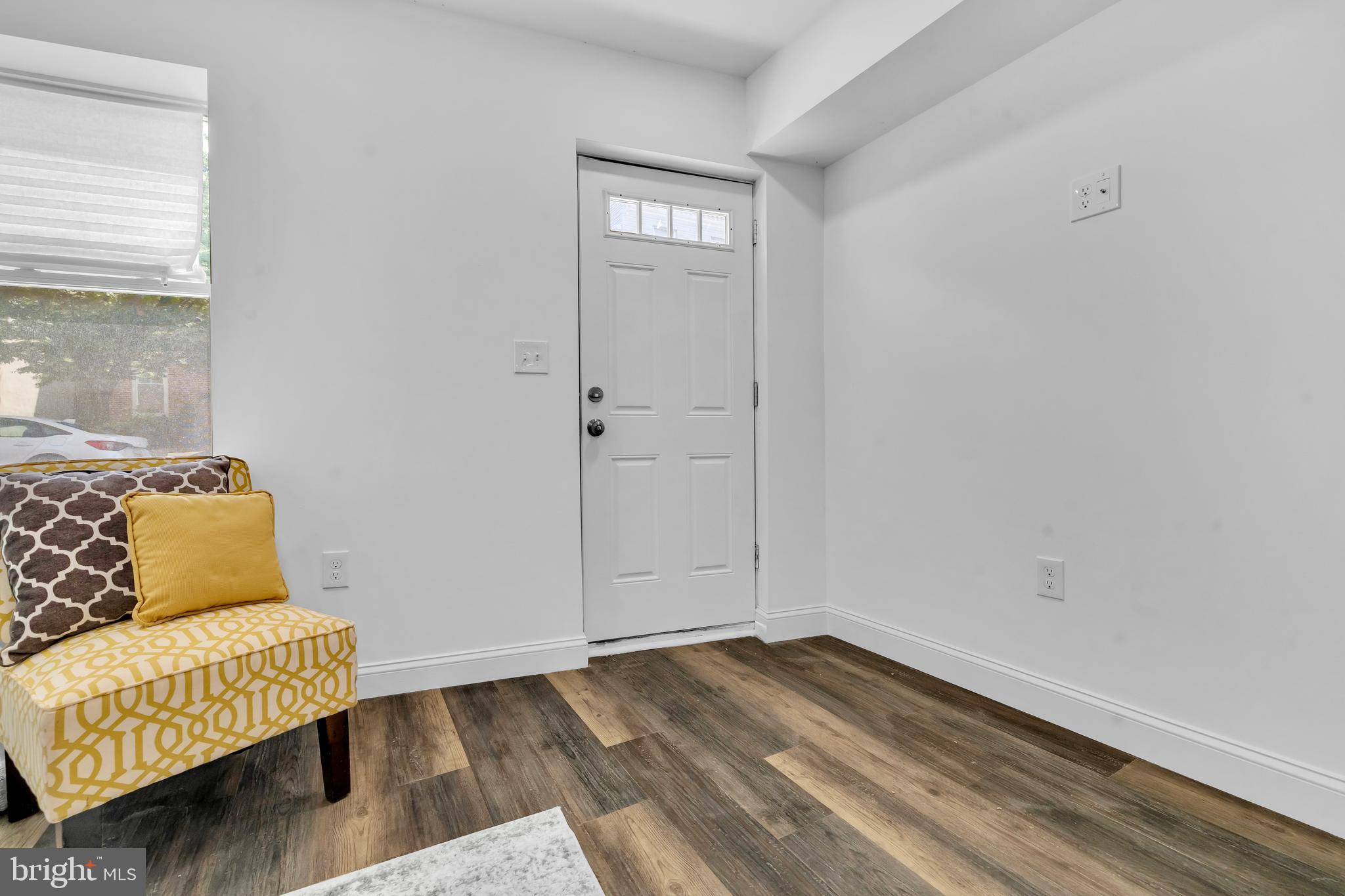 1710 Light Street Baltimore, MD 21230 - Photo 11 of 59 a view of an empty room with wooden floor and a window