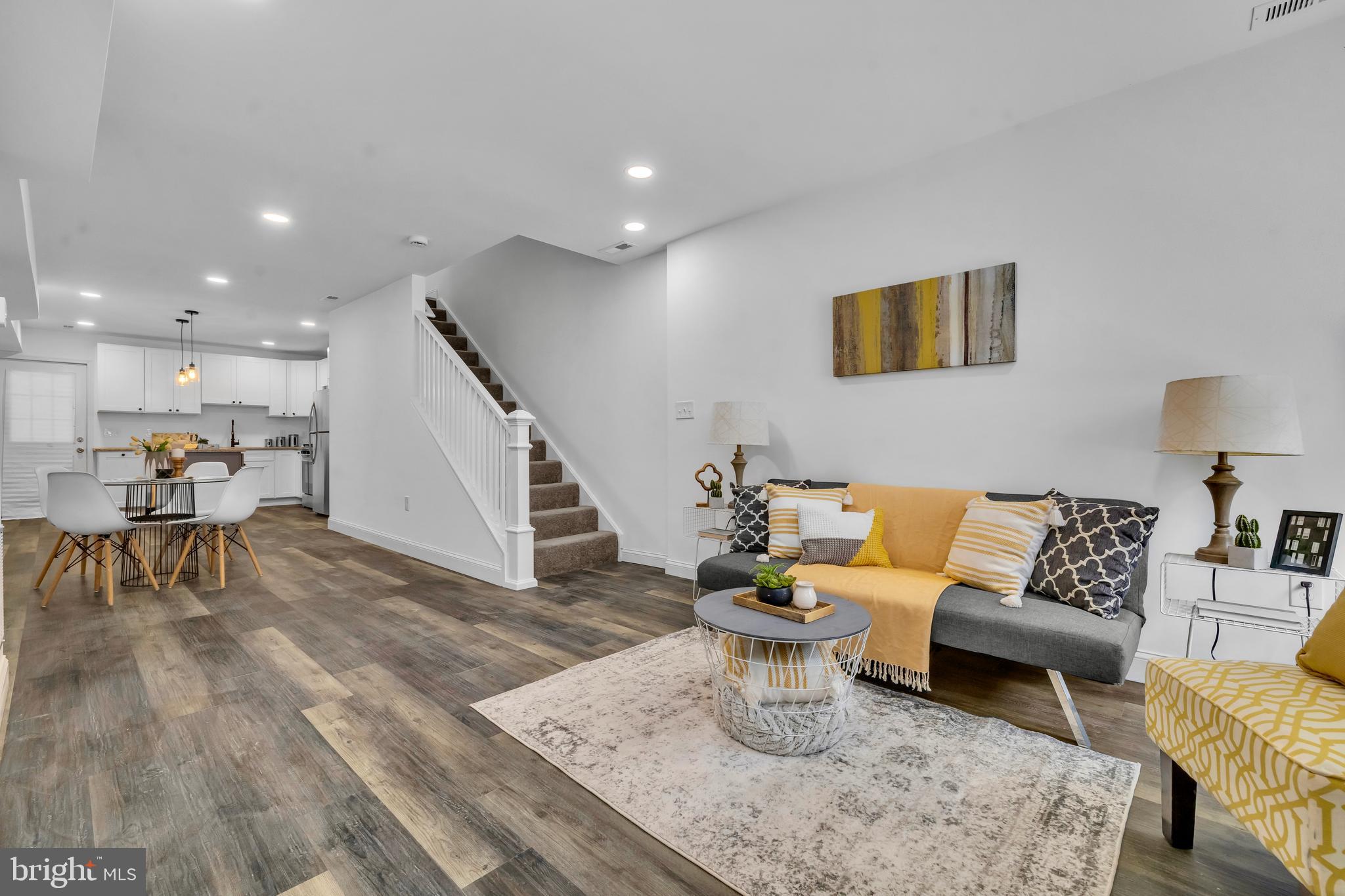 1710 Light Street Baltimore, MD 21230 - Photo 12 of 59 a living room with furniture and a dining table with wooden floor